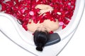 Beautiful asian woman takes a bath in jacuzzi with rose petals Royalty Free Stock Photo