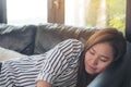 A beautiful asian woman taking a nap during daytime with feeling relaxed Royalty Free Stock Photo