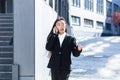 Asian woman talking on the phone, business woman on a break walking near the office Royalty Free Stock Photo