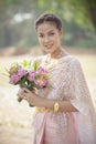 Beautiful asian woman toothy smiling face and pink lotus flower Royalty Free Stock Photo