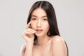 Beautiful Asian woman touching soft cheek smile with clean and fresh skin