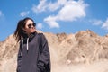 A beautiful Asian woman tourist standing in front of mountain and blue sky background Royalty Free Stock Photo