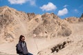 A beautiful Asian woman tourist standing in front of mountain and blue sky background Royalty Free Stock Photo