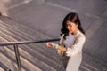 beautiful asian woman using smart watch on stairs in the city Royalty Free Stock Photo