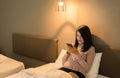 Beautiful asian woman using smartphone on bed at night,Eye diseases and eyes disorders concept Royalty Free Stock Photo