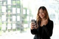 Beautiful asian woman using smartphone, exciting and celebrating with good news of business successful. Small business startup Royalty Free Stock Photo