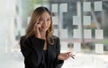 Beautiful asian woman using smartphone, exciting and celebrating with good news of business successful. Small business startup Royalty Free Stock Photo