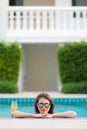 Asian woman in pool with glass of orange juice Royalty Free Stock Photo