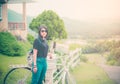 Beautiful asian woman. Wear a casual dress black t-shirt with Green jeans. Backpack. Standing with a retro style bicycle, Vintage.