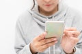 Beautiful Asian woman wearing grey casual shirt holding smartphone on white background and copy space.  Cute Asian woman is Royalty Free Stock Photo