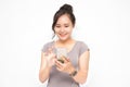 Beautiful Asian woman wearing grey casual shirt holding smartphone on white background and copy space.  Cute Asian woman is Royalty Free Stock Photo