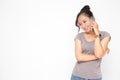 Beautiful Asian woman wearing grey casual shirt holding smartphone on white background and copy space.  Cute Asian woman smiling Royalty Free Stock Photo