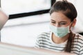 Beautiful asian woman wearing protection mask work from home in the morning. Young asian female working with computer stay at home Royalty Free Stock Photo