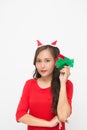 Beautiful Asian woman wearing small Santa hat and wearing red dress holding red gift box on white background Royalty Free Stock Photo