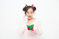 Beautiful Asian woman wearing small Santa hat and wearing pink sweater holding red gift box on white background Royalty Free Stock Photo