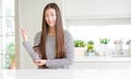 Beautiful Asian woman wearing stripes sweater with a big smile on face, pointing with hand and finger to the side looking at the Royalty Free Stock Photo