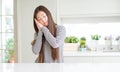 Beautiful Asian woman wearing stripes sweater sleeping tired dreaming and posing with hands together while smiling with closed Royalty Free Stock Photo