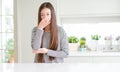 Beautiful Asian woman wearing stripes sweater smelling something stinky and disgusting, intolerable smell, holding breath with Royalty Free Stock Photo