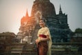 beautiful asian woman wearing thai tradition dress smiling with happiness standing against old stupa in ayutthaya world heritage Royalty Free Stock Photo