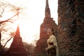 beautiful asian woman wearing thai tradition dress standing against brick wall at old temple of ayutthaya world heritage site of Royalty Free Stock Photo