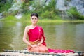 Woman wearing Thai traditional dress sitting on bamboo raft Royalty Free Stock Photo