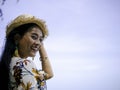 Beautiful asian woman wearing vintage dress with pineapple earrings travelling the seaside Royalty Free Stock Photo