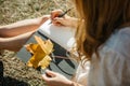 Beautiful asian woman in white dress sit under the tree  writing and thinking in the park with autumn leaves Royalty Free Stock Photo