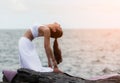 Beautiful asian woman in white dress sitting on asana is practicing making pose yoga Royalty Free Stock Photo