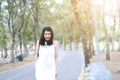 Beautiful asian woman in white dress walking and smiling in nature park. enjoy on holiday in the Garden Royalty Free Stock Photo