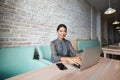 Beautiful Asian woman working on net-book during morning breakfast in cafe bar Royalty Free Stock Photo