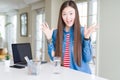 Beautiful Asian woman working using computer laptop celebrating crazy and amazed for success with arms raised and open eyes Royalty Free Stock Photo