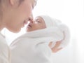 A beautiful Asian woman carried her newborn baby and kiss with happiness Royalty Free Stock Photo
