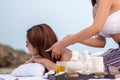 Beautiful asian woman enjoying spa massage therapy on the beach Royalty Free Stock Photo