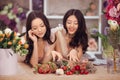 Beautiful asian women florists with bouquet of flowers in flower store