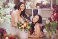 Beautiful asian women florists with bouquet of flowers in flower store