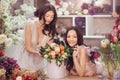 Beautiful asian women florists with bouquet of flowers in flower store