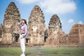 Beautiful Asian women, beautiful Thai people, casual wear, and wearing a hat standing in front of Phra Prang Sam Yot, Lop Buri Royalty Free Stock Photo