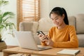 Beautiful Asian women wear long sleeve yellow using text message mobile phone. happy young woman using a phone smile on the face Royalty Free Stock Photo