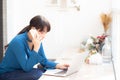 Beautiful asian young businesswoman excited and glad of success work with laptop, girl taking mobile smart phone Royalty Free Stock Photo