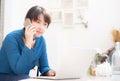 Beautiful asian young businesswoman excited and glad of success work with laptop, girl taking mobile smart phone Royalty Free Stock Photo