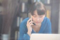 Beautiful asian young businesswoman excited and glad of success work with laptop, girl taking mobile smart phone Royalty Free Stock Photo