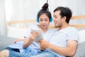 Beautiful asian young couple listening to music with tablet. Royalty Free Stock Photo