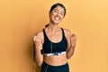 Beautiful asian young sport woman wearing sportswear and earphones very happy and excited doing winner gesture with arms raised, Royalty Free Stock Photo