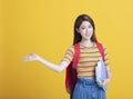 asian young student holding books and showing something Royalty Free Stock Photo