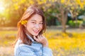 Beautiful Asian young teen girl with nature yellow flower Royalty Free Stock Photo