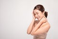 Beautiful Asian young woman close her eyes touching soft cheek smile with clean and fresh skin Royalty Free Stock Photo