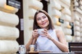 Beautiful Asian young woman with cup of coffee. Woman enjoys fresh coffee in the morning with sunrise at coffe shop Beautiful Royalty Free Stock Photo