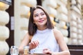 Beautiful Asian young woman with cup of coffee. Woman enjoys fresh coffee in the morning with sunrise at coffe shop Beautiful Royalty Free Stock Photo