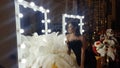 Beautiful asian young woman and decorative ostrich feathers on a gold table next to a make-up mirror Royalty Free Stock Photo