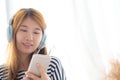 Beautiful asian young woman enjoy listen music with headphone an Royalty Free Stock Photo